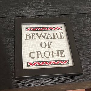 Framed Cross-stitch sign.